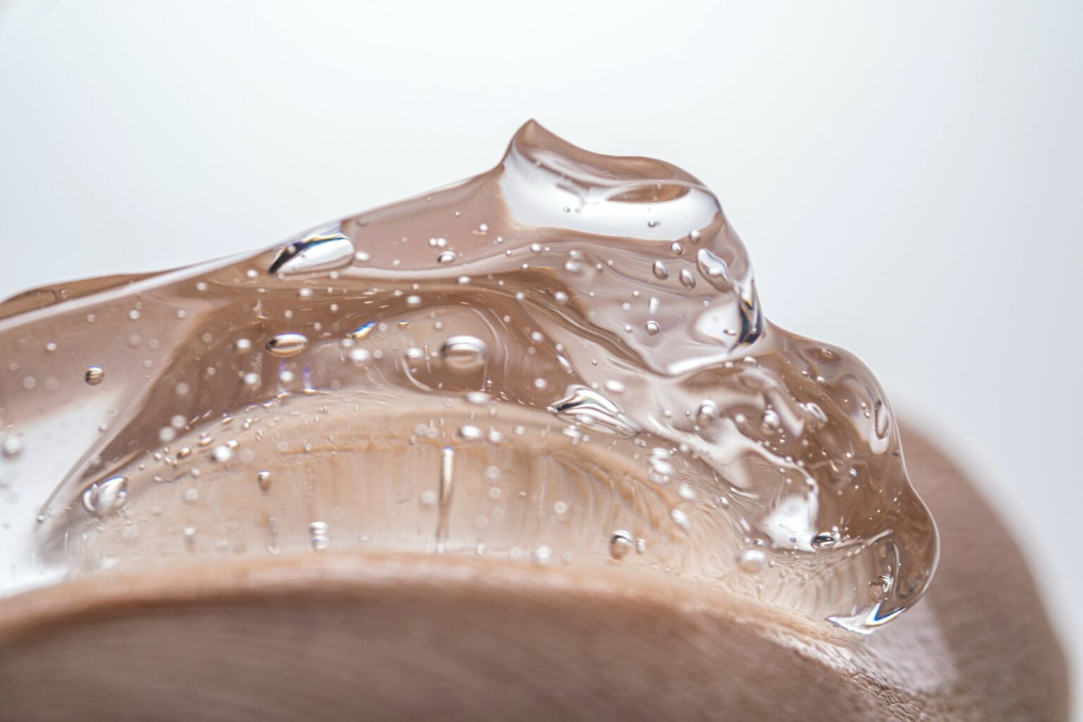 The texture of a thick cosmetic hyaluronic gel on the skin